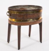 A George III mahogany and brass bound oval wine cooler on a stand:, with metal liner,