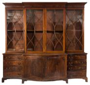 A mahogany breakfront library bookcase:, the upper part with a moulded cornice,