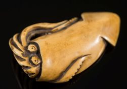A Japanese carved ivory netsuke of a squid: signed, Meiji period, 6cm. long.