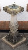 A 'stone' sundial with bronze dial plate:, the square section baluster column on stepped base,