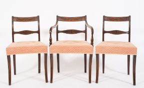 A set of eight Regency carved mahogany dining chairs:,