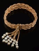 A mesh-link bracelet: the clasp overlayed with a cultured pearl-set tassle, 42.5gms gross weight.