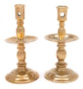 A matched pair of 17th century brass Heemskerk candlesticks: each with pierced cylindrical nozzle,