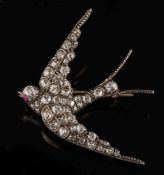 A late 19th century gold, silver and diamond 'swallow' brooch: with round,