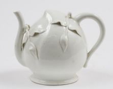 A Meissen cadogan teapot: in the white, of peach shaped form with loop handle and scrolling spout,