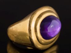 An oval cabochon amethyst single-stone ring: the amethyst approximately 8.8mm long x 3.