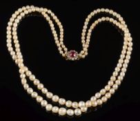 A baroque cultured pearl and natural pearl two string necklace: with 'red spinal' and diamond