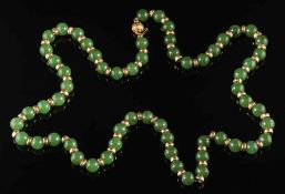 A jade bead single-string necklace: each bead approximately 8mm diameter and between hammered