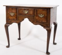 An 18th Century oak and crossbanded lowboy:,