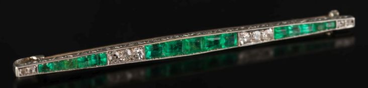 An Art Deco emerald and diamond bar brooch: with graduated, rectangular emeralds between circular,