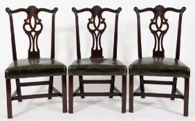 A set of six George III carved mahogany dining chairs in the Chippendale taste:,