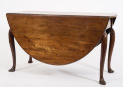 A mid 18th Century mahogany oval drop flap dining table:, with a hinged top on cabriole legs,