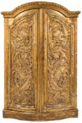 A 19th century Continental carved giltwood domed and bow-fronted armoire: with a moulded and