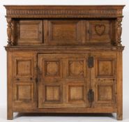 A late 17th/early 18th century oak court cupboard: the upper part with a moulded cornice and