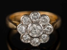 A diamond mounted circular cluster ring: with circular brilliant-cut diamonds estimated to weigh at