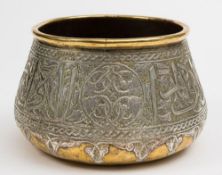 An Indo-Persian silver and brass bowl: of squat ovoid form with banded decoration of script and