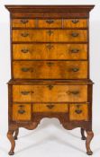An 18th century and later walnut and feather banded chest on later stand:,