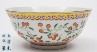 A Chinese porcelain bowl: the exterior enamelled in the famille rose palette with peach branches