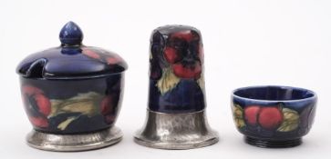 A Moorcroft Tudric pewter mounted condiment set: comprising a salt,