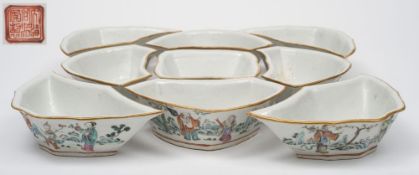 WITHDRAWN LOT 750 A Chinese famille rose hors d'oeuvres set: the nine shaped bowls formed to fit