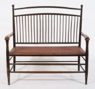 An Aesthetic movement ash twin seat settee:, with a curved spindle back,