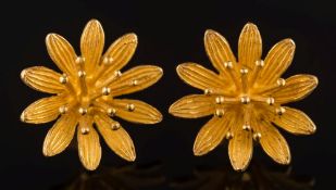 A pair of flower-head ear studs: with butterfly scrolls stamped '750'.