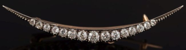 A diamond mounted crescent brooch: with graduated round old brilliant-cut diamonds estimated to