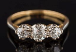 A diamond mounted three-stone ring: with graduated round old brilliant-cut diamonds approximately 0.