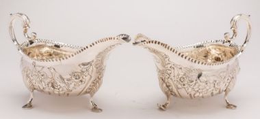 A pair of George III silver sauce boats, maker John Craig, Dublin, 1770:, crested,