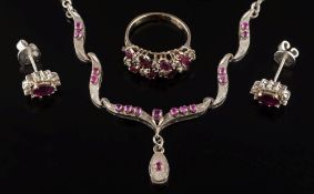 A pair of ruby and diamond mounted oval cluster earrings: a ruby and diamond mounted cluster ring