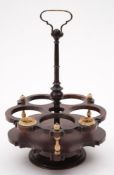 A 19th century rosewood and bone mounted revolving bottle stand: of circular form with central