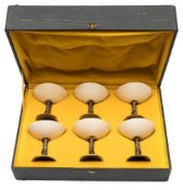 A set of six Chinese silver mounted ostrich egg goblets: the shallow bowls of circular outline