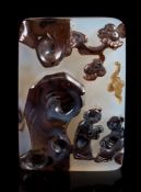 A Chinese silhouette agate rectangular plaque: the darker stone carved with two figures, a bat,