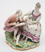 A Vienna porcelain group of a portrait painter and lady: the artist with a palette on his knee and