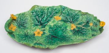 A George Jones majolica cucumber tray: of shaped oval form moulded with verdant leaves and yellow