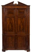 A George III mahogany and inlaid standing corner cupboard:, in two parts,
