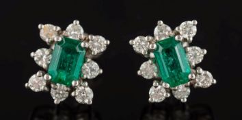 A pair of white metal, emerald and diamond rectangular cluster ear studs: the emeralds 6.
