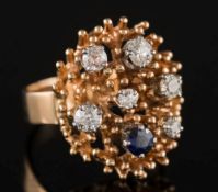 A Modernist sapphire and diamond mounted oval cluster ring: with six graduated,