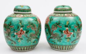 A pair of Chinese globular ginger jars and covers: painted in iron red,