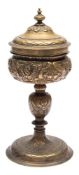 A late 17th century Continental brass chalice and cover: with domed lid having a tied wreath border,