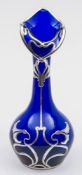 An Art Nouveau silver overlay vase: the cobalt blue body of 'organic' form with heavy silver