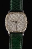 A gentleman's diamond-set quartz wristwatch: the cushion shaped dial pave-set throughout with