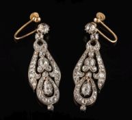 A pair of diamond pendant earrings: each with a circular,