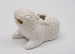 A Chinese porcelain brush washer: modelled in the form of a warty toad with a garland on it's back,
