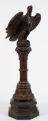A Victorian carved oak 'Eagle' lectern:, the winged figure perched on a rocky mound,