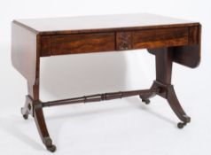 A Regency rosewood sofa table:, the hinged top with rounded corners,