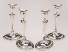 A set of four George V silver candlesticks,maker Goldsmiths & Silversmiths Co Ltd, London,