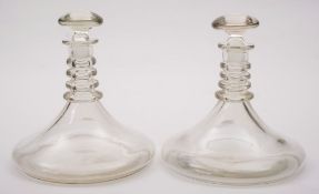 A pair of ship's decanters: of traditional blown form with quadruple neck rings and simple mushroom
