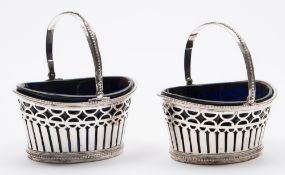 A pair of French silver swing-handled bonbon baskets: of oval outline,
