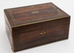 A Victorian rosewood and brass inlaid travelling vanity box: the hinged lid enclosing a fitted